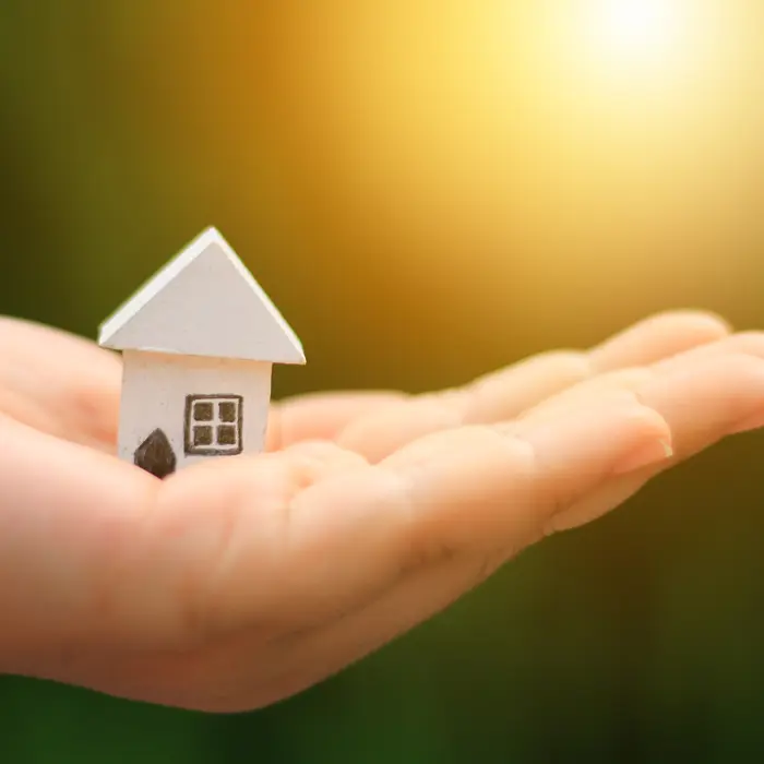 Small house being held in a hand